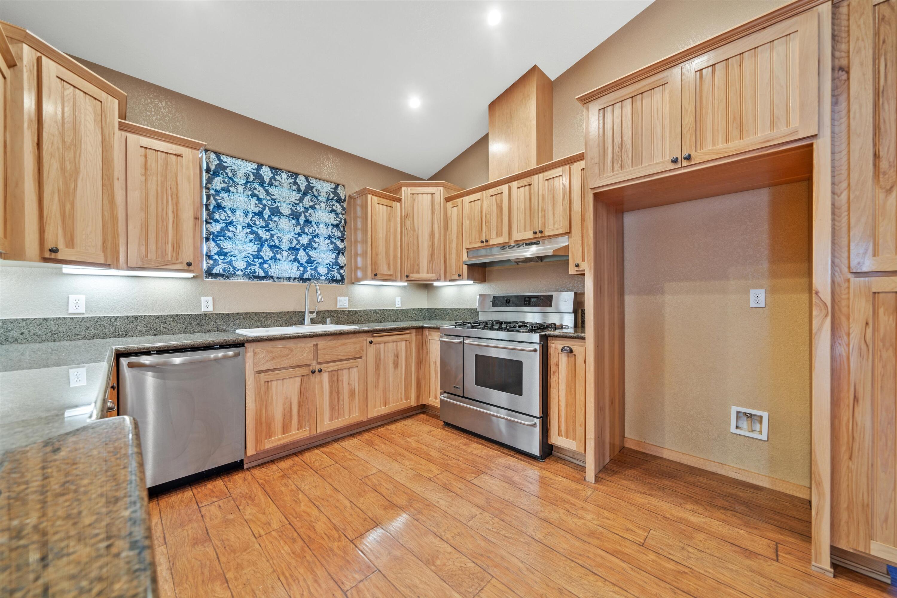 28321 Pimlico Way Tehachapi, CA 93561 - Photo 21 of 23 a kitchen with stainless steel appliances granite countertop a refrigerator sink and cabinets