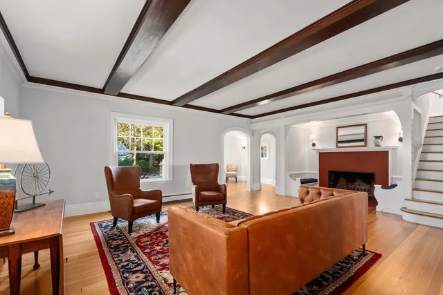 a living room with furniture a fireplace and a table