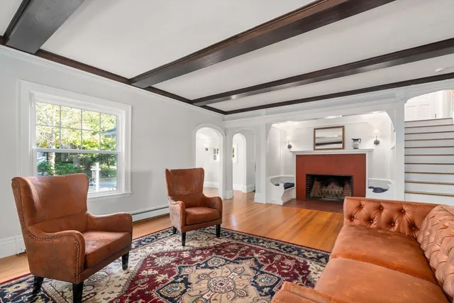 a living room with furniture a flat screen tv and a fireplace