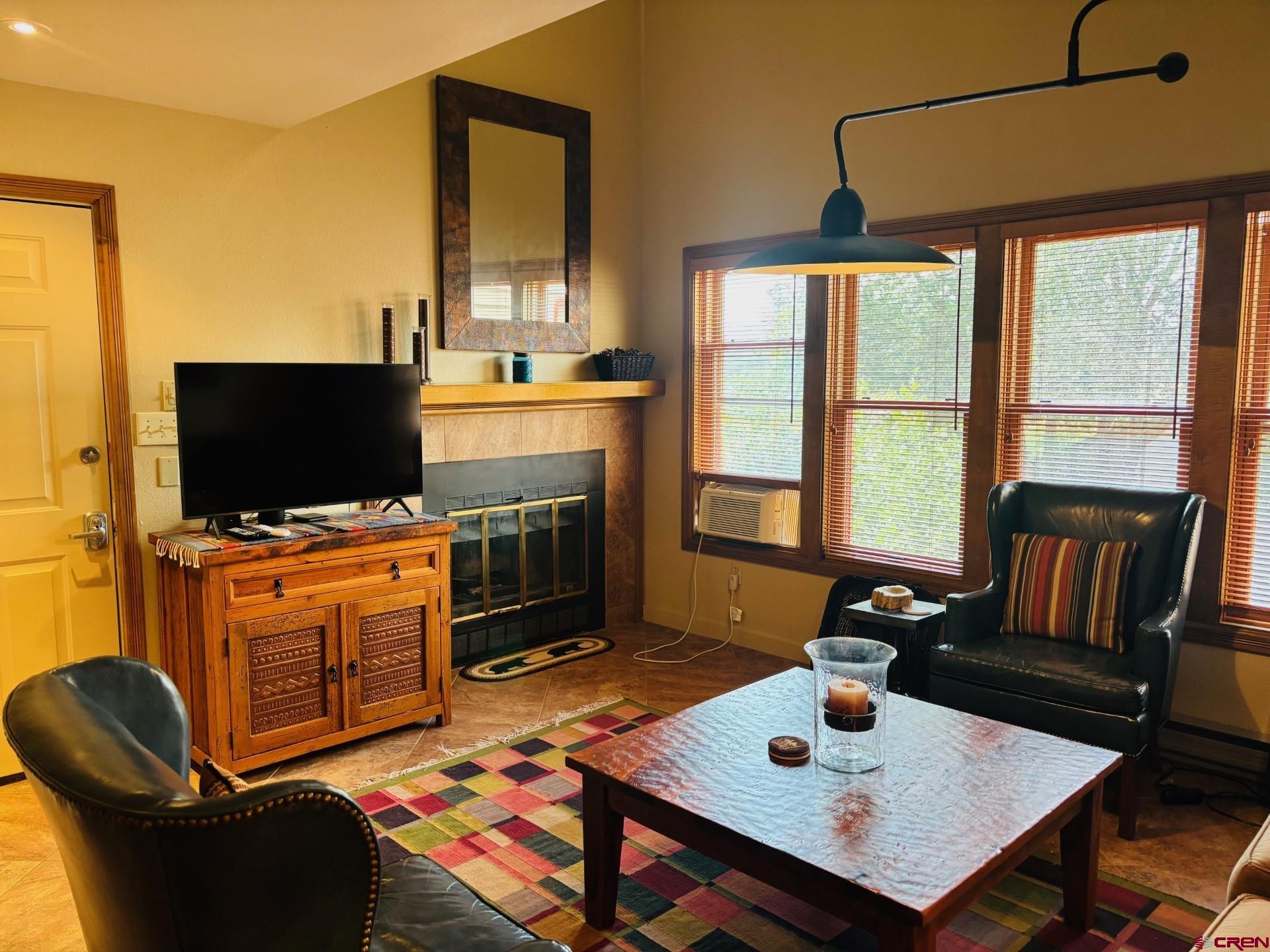 a living room with furniture and flat screen tv