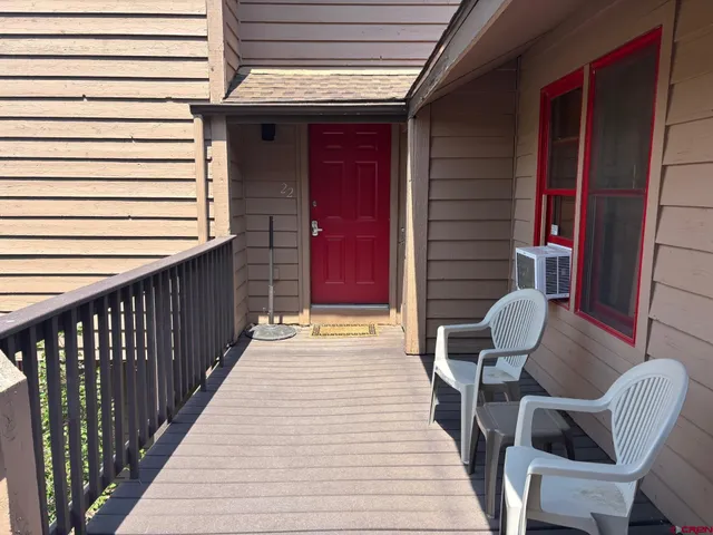 a wooden bench sitting in front of a building