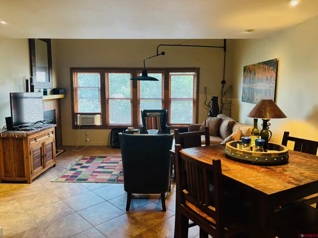 a view of a dining room with furniture and a window