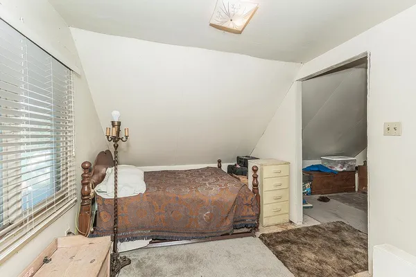 a bedroom with a bed and a walk in closet