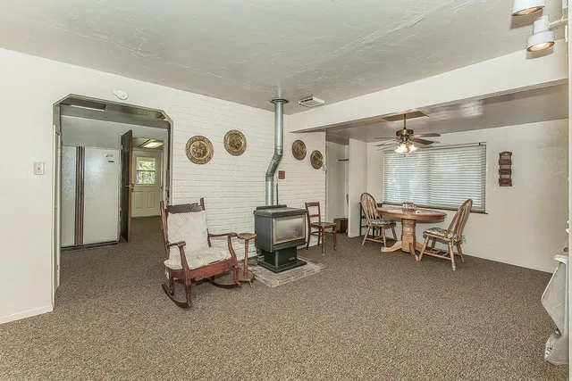 a view of a livingroom with furniture and a window