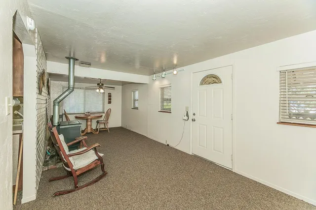 a room with a chair and white walls