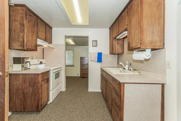 a kitchen with a stove and a sink