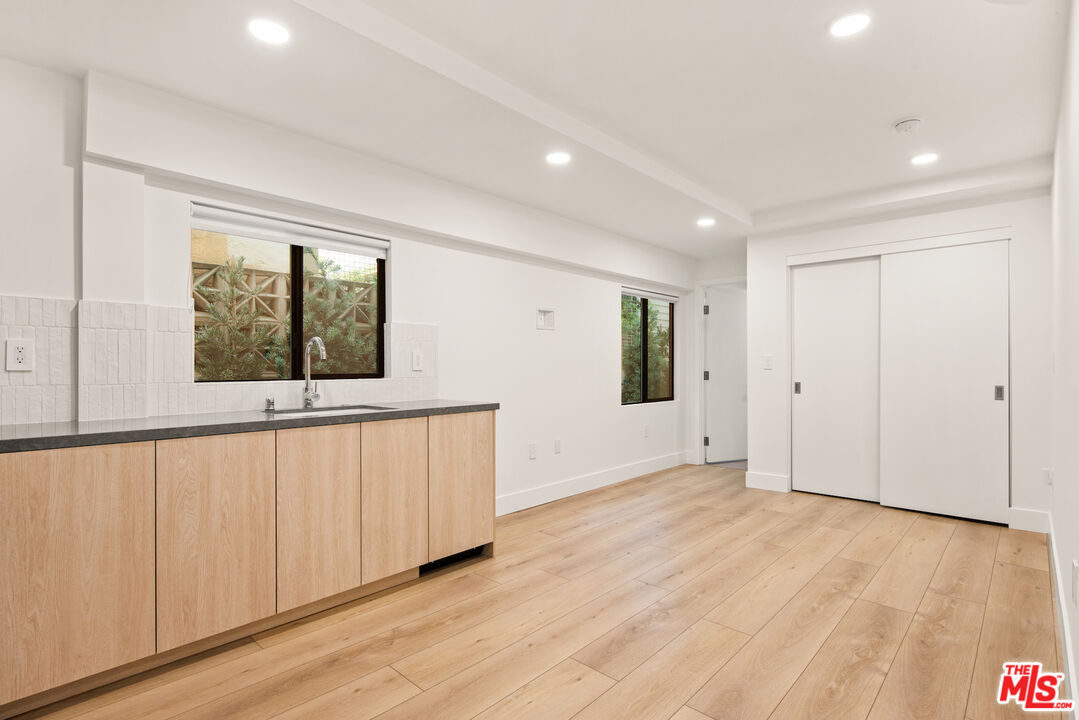 2811 3rd Street, Unit 13 Santa Monica, CA 90405 - Photo 3 of 13 a view of an empty room with wooden floor and a window