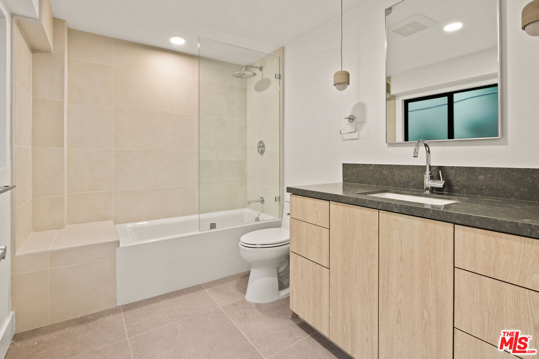 2811 3rd Street, Unit 13 Santa Monica, CA 90405 - Photo 9 of 13 a bathroom with a granite countertop sink toilet and shower