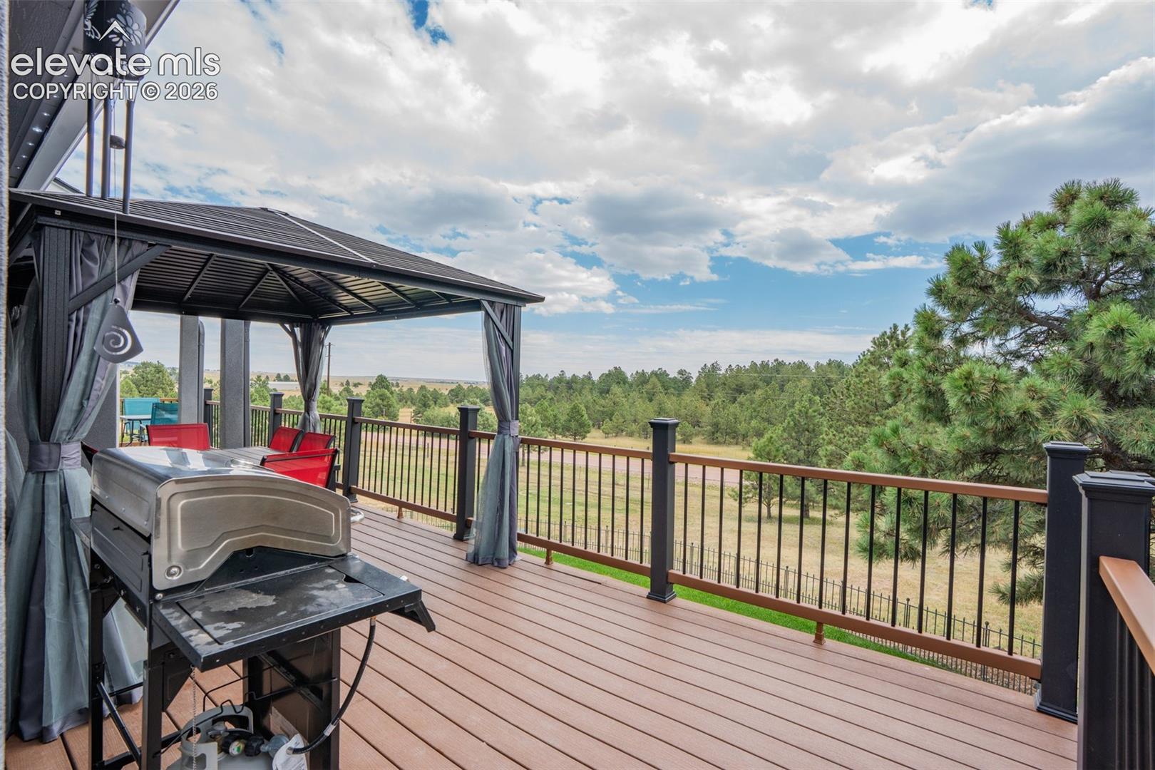 17370 Sweet Road Peyton, CO 80831 - Photo 12 of 47 44x20 newer no maintenance deck gives you the space to relax and enjoy your views; deck encompasses the front and side of the home, pergola is included with purchase.