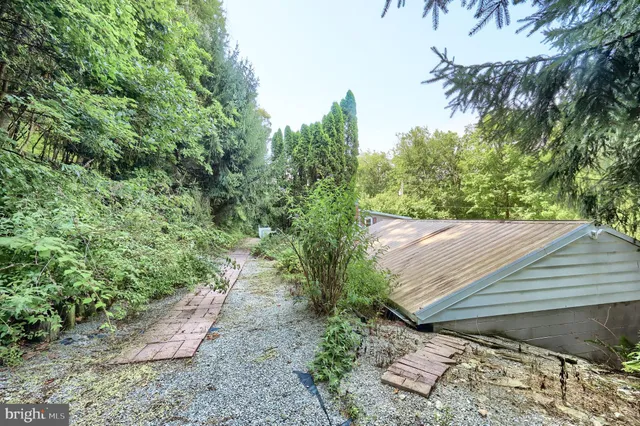 a view of house with backyard and sitting area
