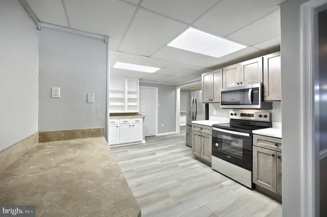 a kitchen with stainless steel appliances granite countertop a refrigerator stove and sink