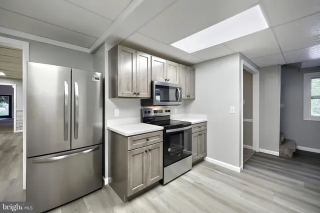a kitchen with a sink a stove and cabinets
