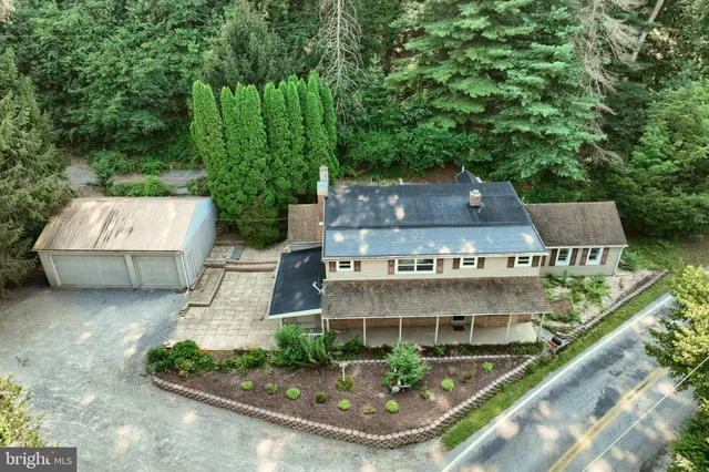 an aerial view of a house with a yard