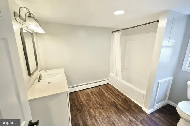 a bathroom with a sink mirror and vanity