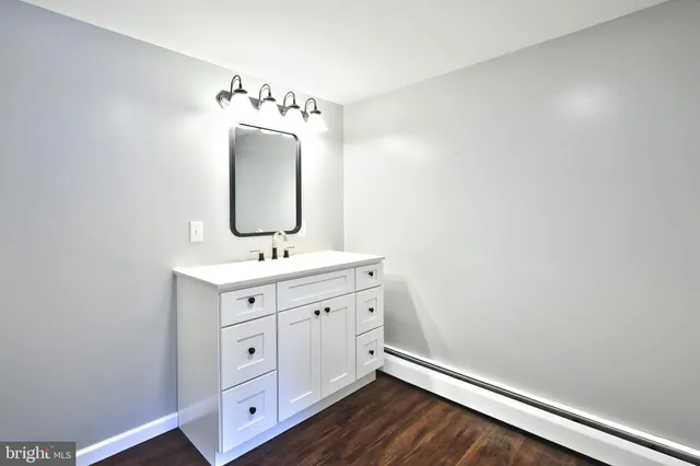 a bathroom with a shower sink and mirror