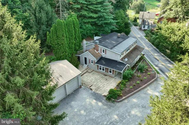 an aerial view of a house with garden space and street view