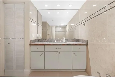 a bathroom with a sink a vanity and a mirror