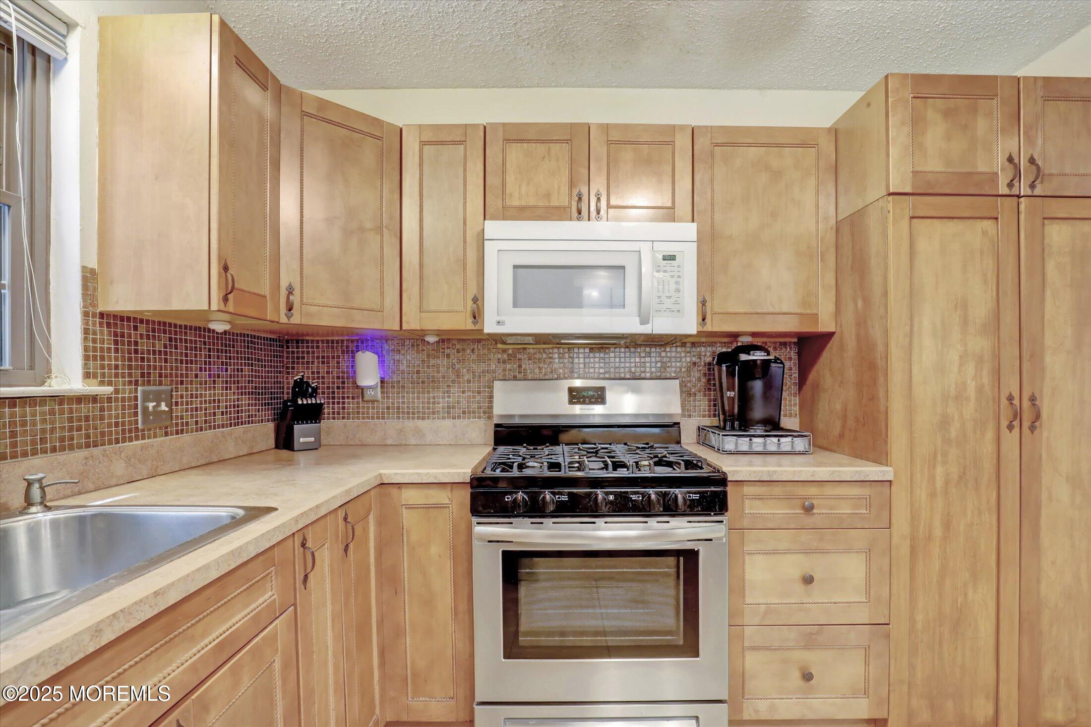 95 Azalea Circle Jackson, NJ 08527 - Photo 13 of 38 a kitchen with granite countertop cabinets stainless steel appliances and a sink