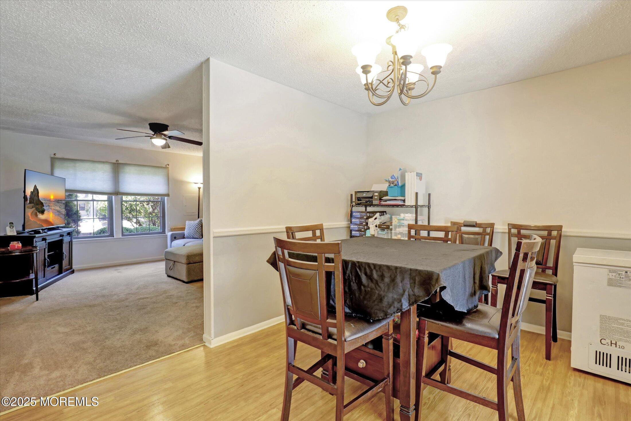 95 Azalea Circle Jackson, NJ 08527 - Photo 16 of 38 a view of a dining room with furniture and wooden floor