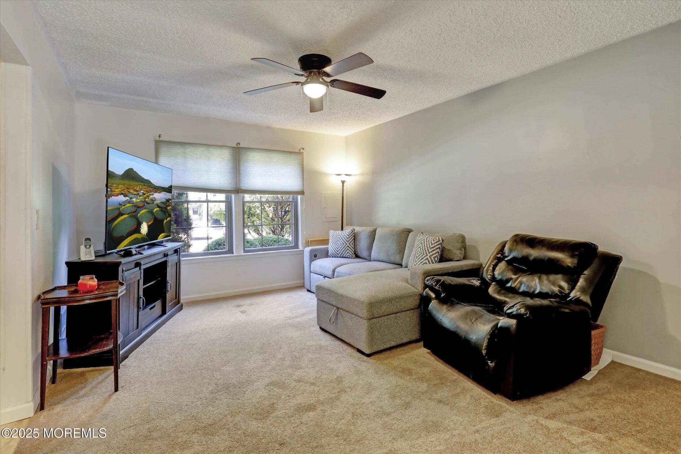 95 Azalea Circle Jackson, NJ 08527 - Photo 19 of 38 a living room with furniture and a flat screen tv
