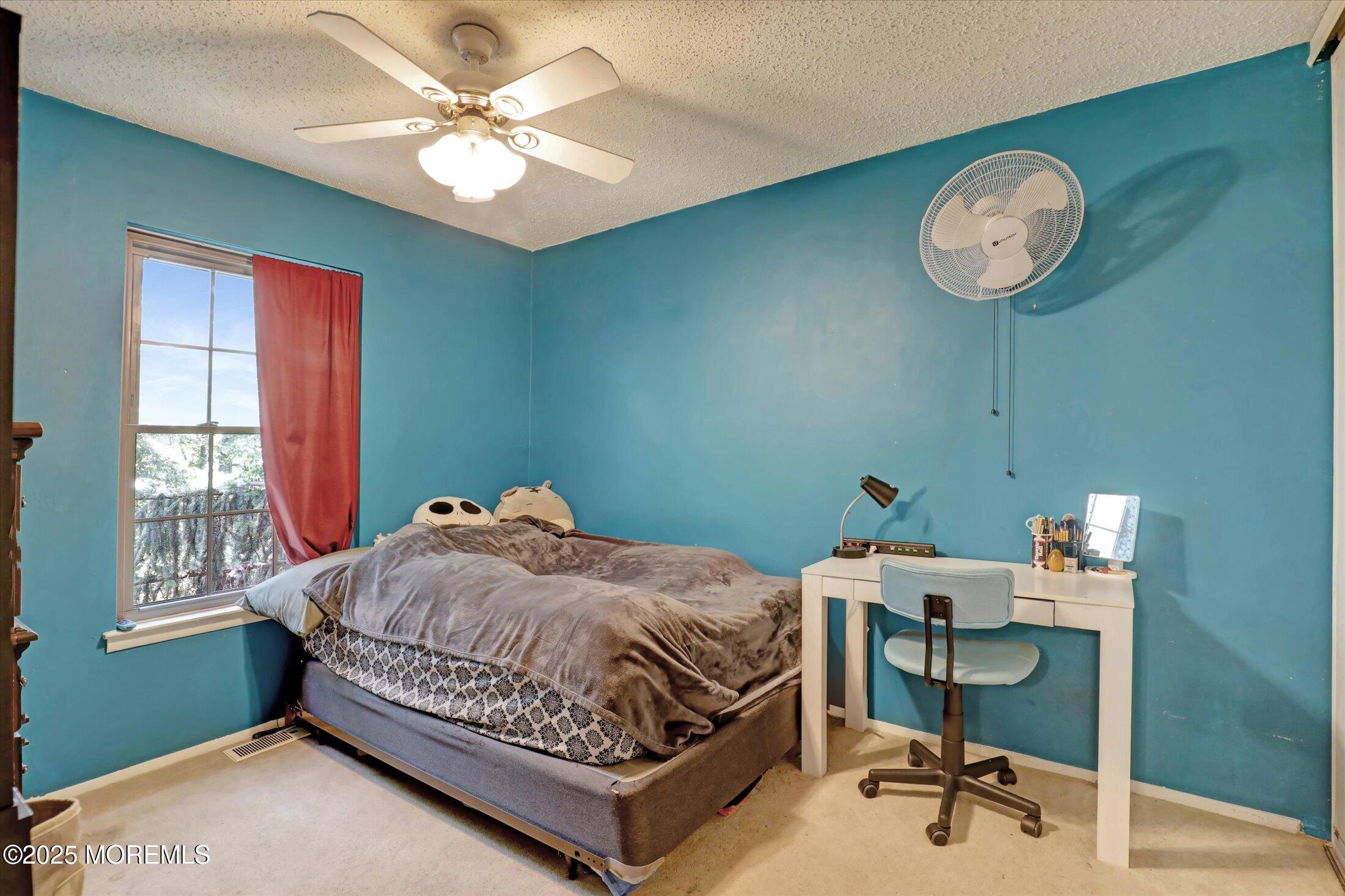 95 Azalea Circle Jackson, NJ 08527 - Photo 30 of 38 a bedroom with a bed and a chandelier