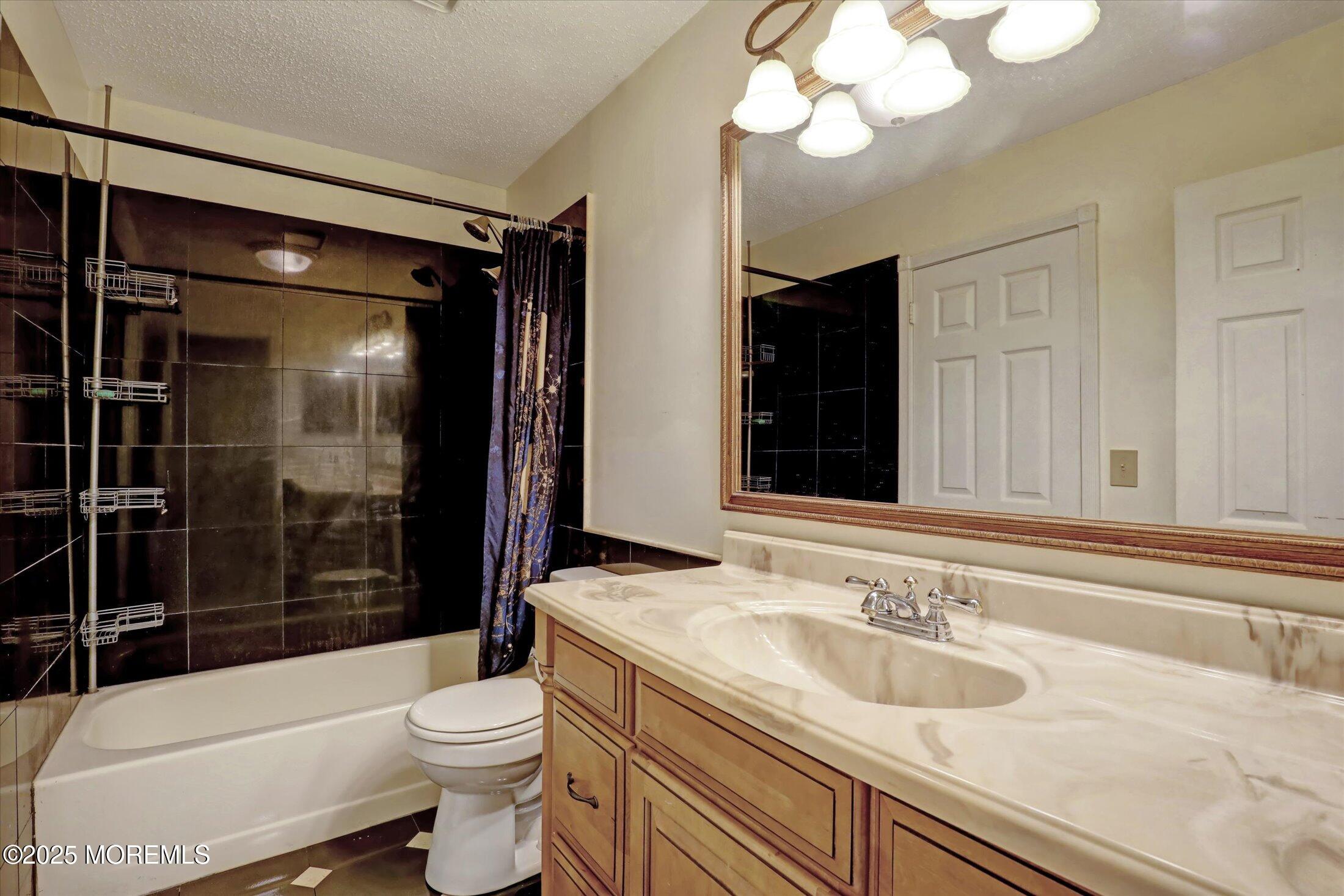 95 Azalea Circle Jackson, NJ 08527 - Photo 4 of 38 a bathroom with a sink a toilet a mirror and shower