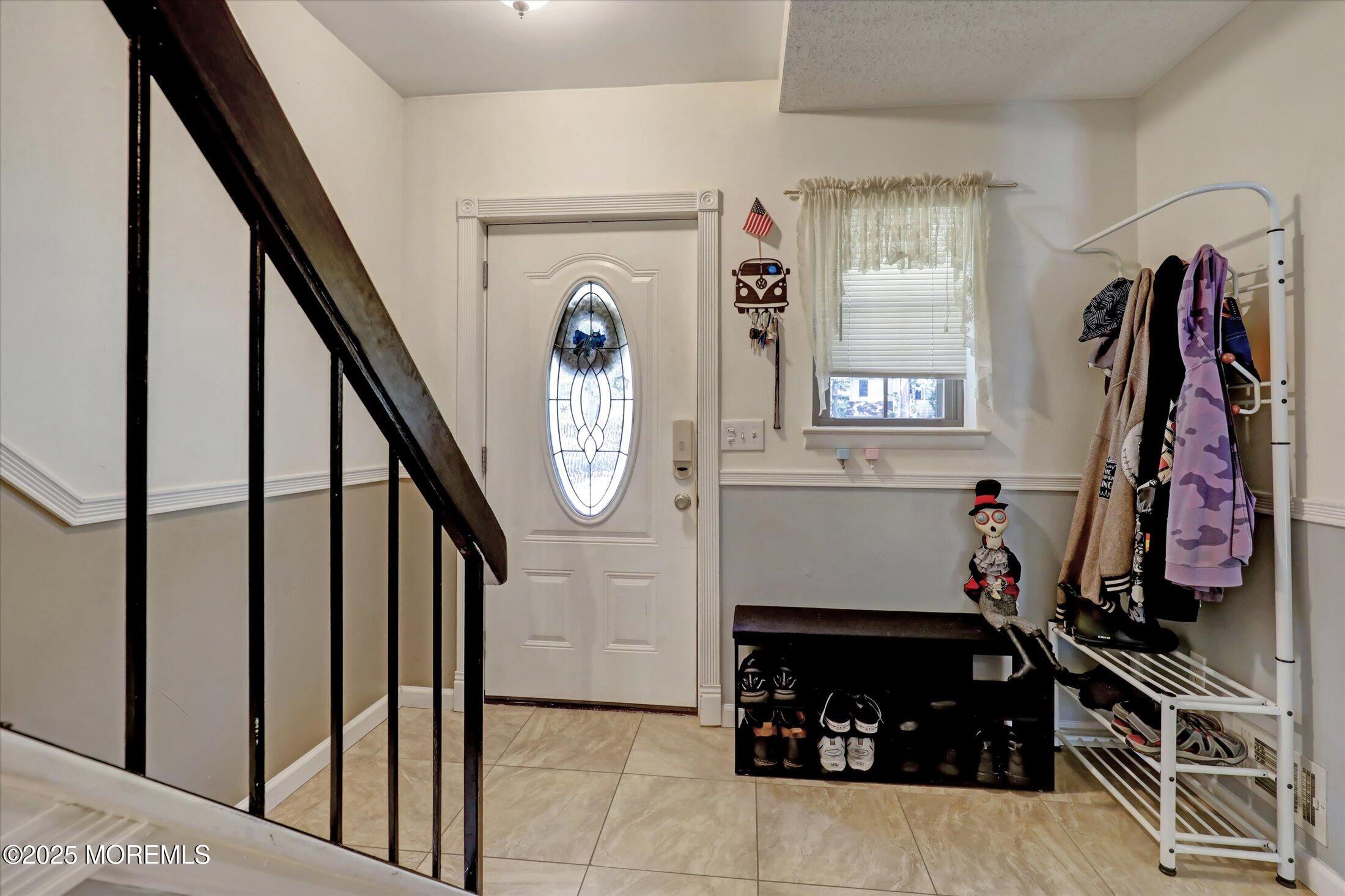 95 Azalea Circle Jackson, NJ 08527 - Photo 10 of 38 a view of a entryway with stairs and a fireplace