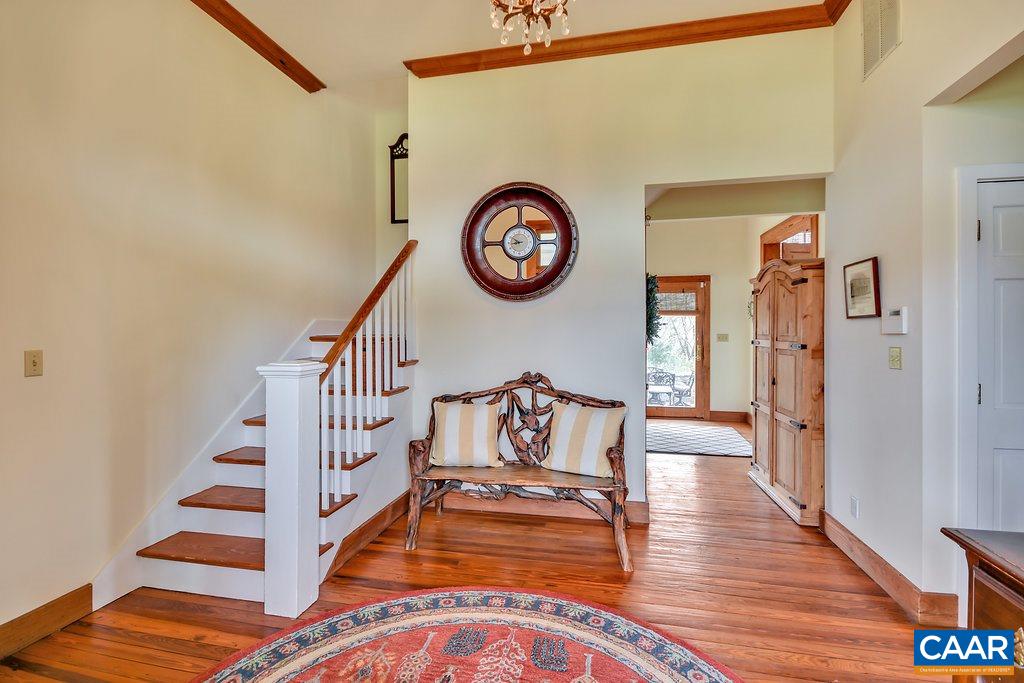 4543 Garth Road Charlottesville, VA 22901 - Photo 11 of 50 a view of staircase with wooden floor and a table