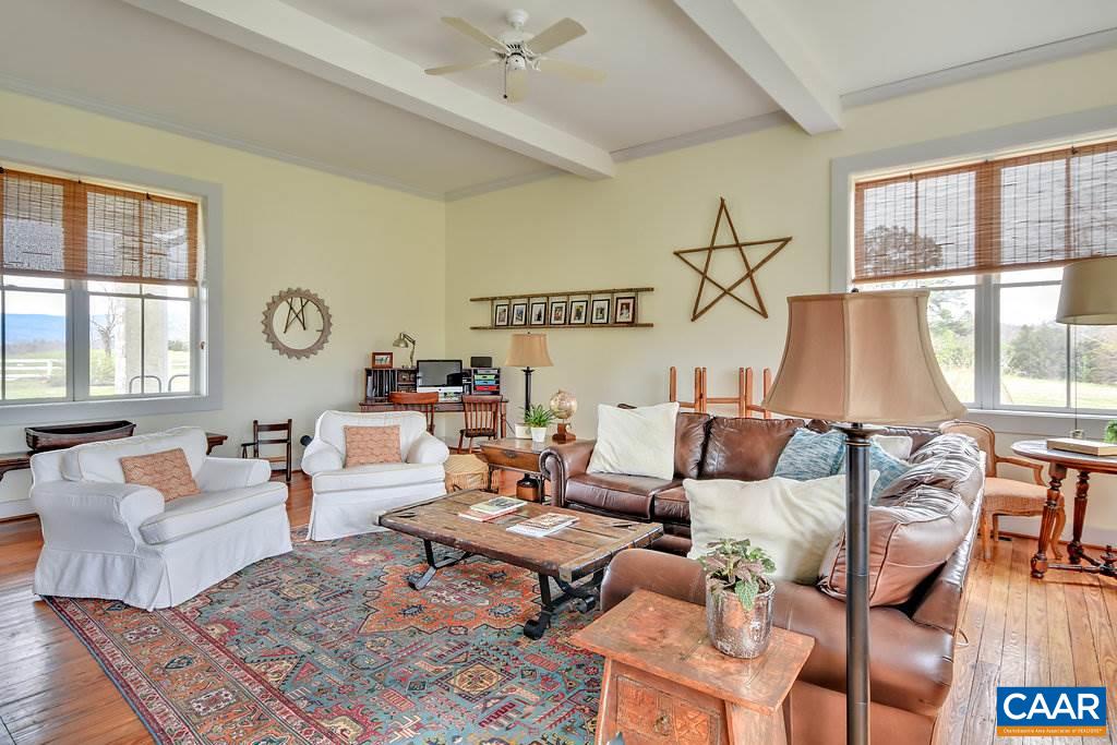 4543 Garth Road Charlottesville, VA 22901 - Photo 13 of 50 a living room with furniture a rug and a lamp