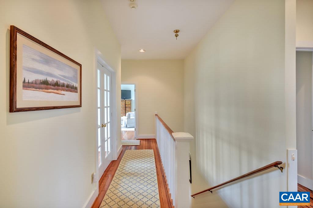 4543 Garth Road Charlottesville, VA 22901 - Photo 26 of 50 a view of a hallway with wooden floor and stairs