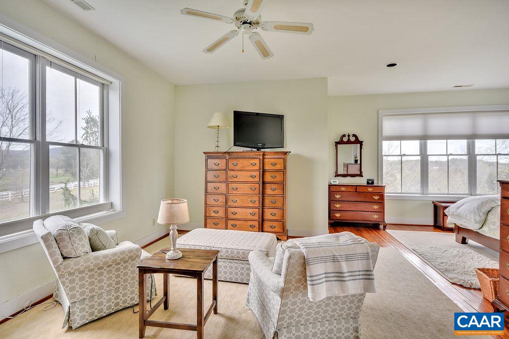 4543 Garth Road Charlottesville, VA 22901 - Photo 29 of 50 a bedroom with furniture and a flat screen tv