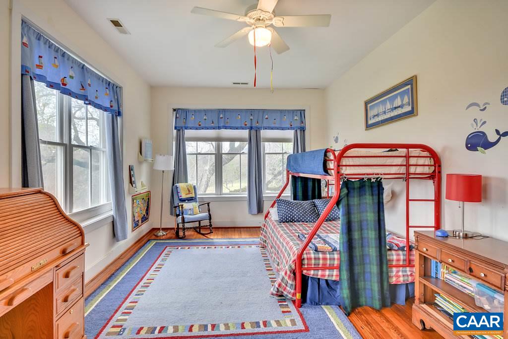 4543 Garth Road Charlottesville, VA 22901 - Photo 32 of 50 a living room filled with furniture and a chandelier