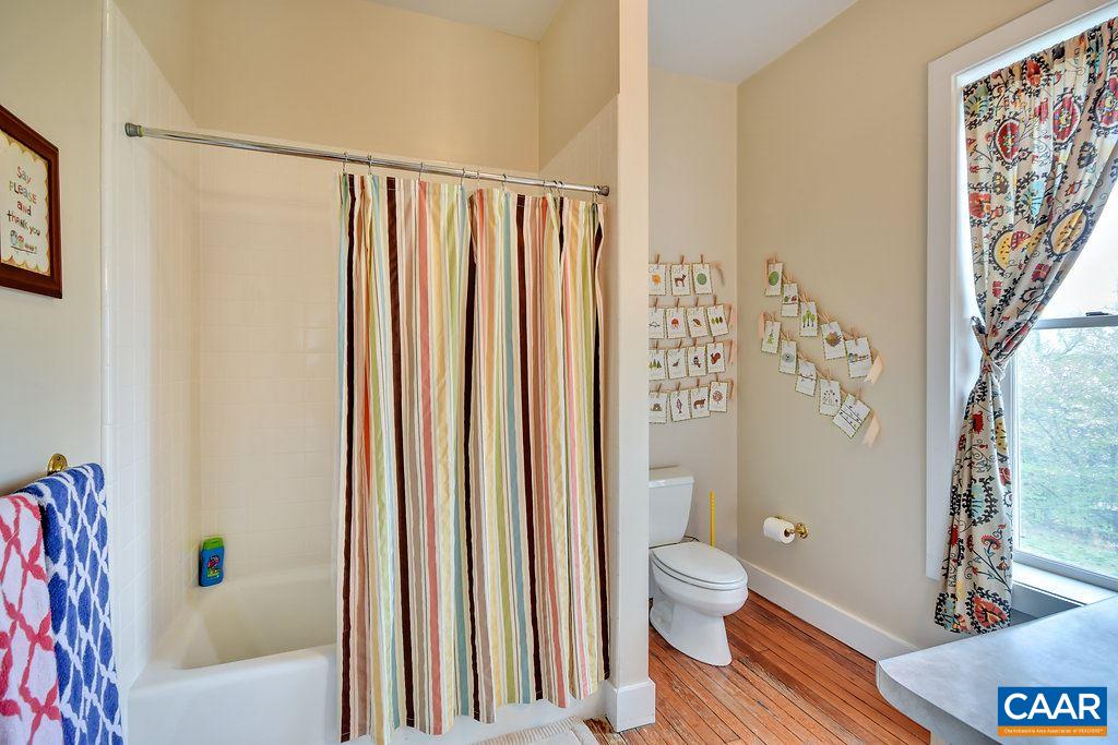 4543 Garth Road Charlottesville, VA 22901 - Photo 33 of 50 a bathroom with a toilet and a shower curtain