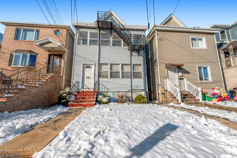 a front view of a house with the garden