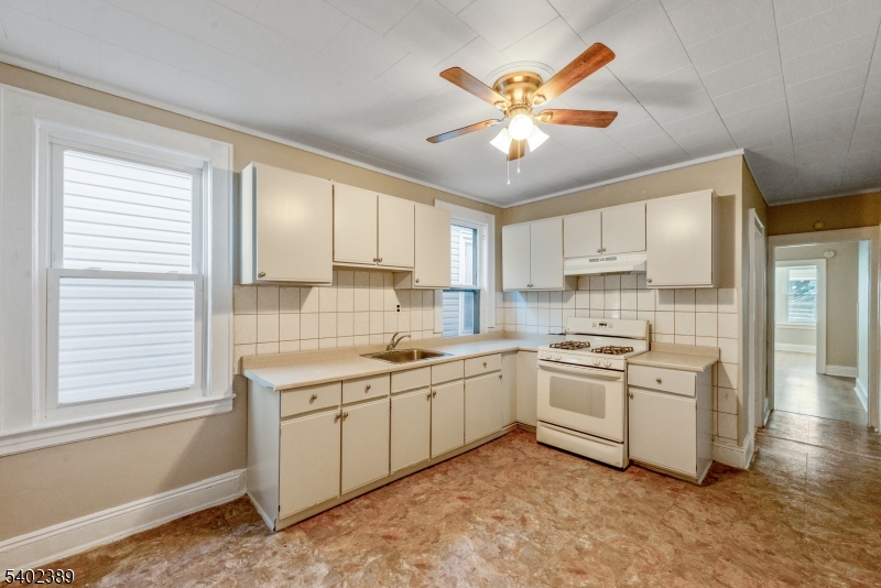 525 Maple Avenue Elizabeth, NJ 07202 - Photo 14 of 17 a kitchen with a sink stove and cabinets