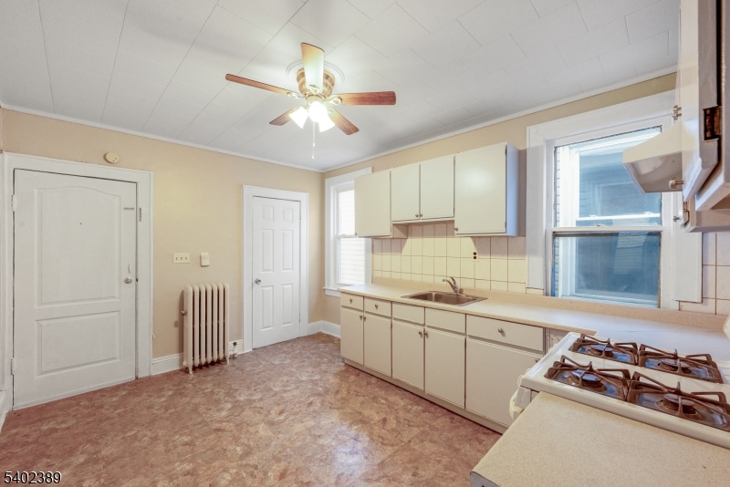525 Maple Avenue Elizabeth, NJ 07202 - Photo 16 of 17 a kitchen with a sink stove and cabinets