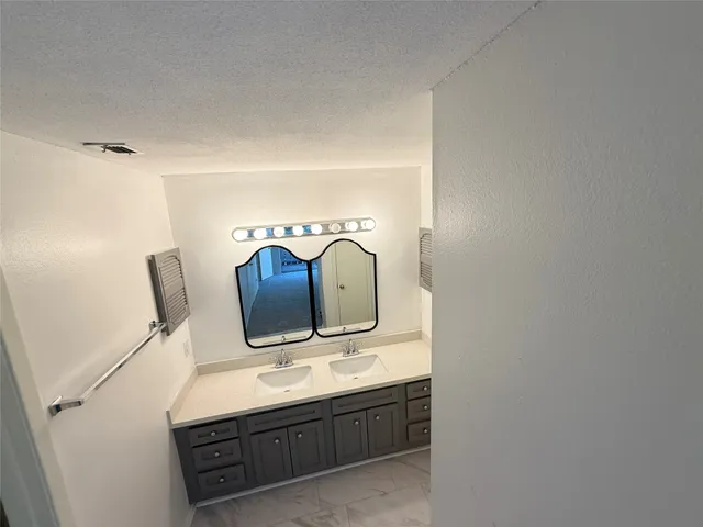 a bathroom with a sink and mirror