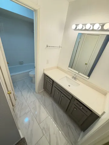 a bathroom with a sink and mirror