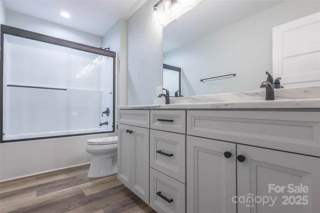 a bathroom with a toilet a sink and shower