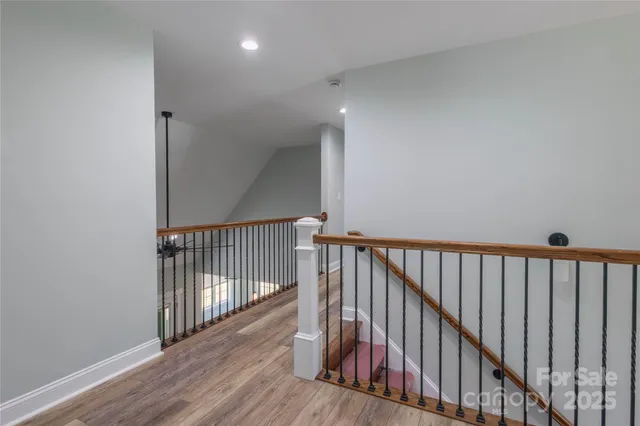 a view of a hallway with wooden floor
