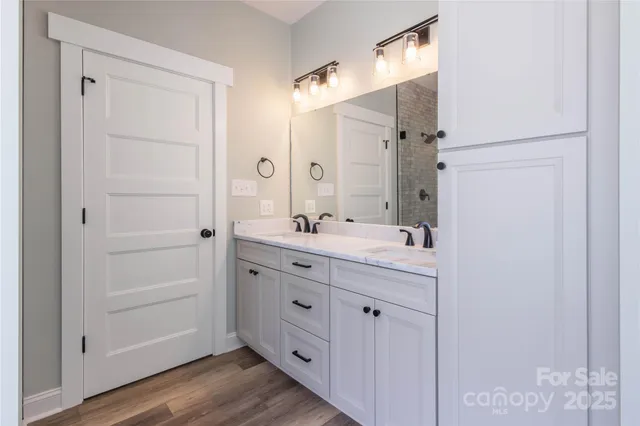 a bathroom with a granite countertop sink two mirror and a
