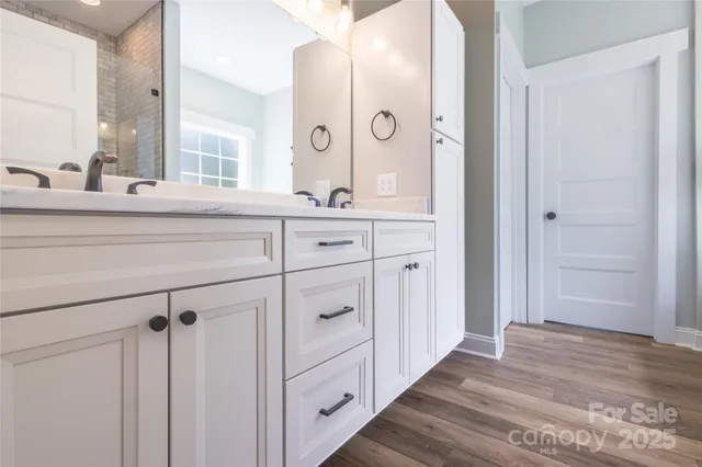 a bathroom with a double vanity sink and mirror