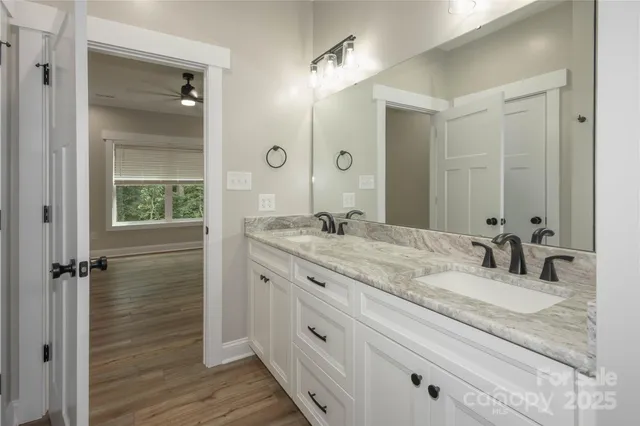 a bathroom with a granite countertop sink mirror and double