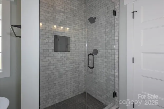 an empty room with a window and a ceiling fan