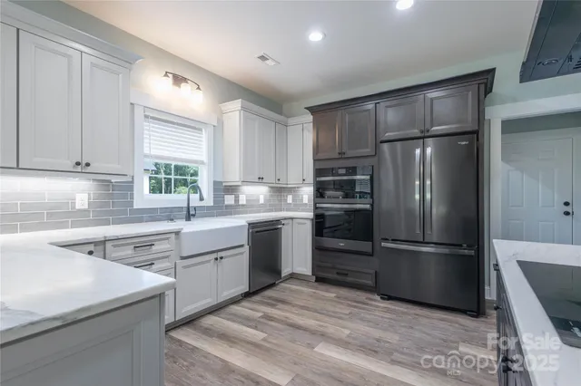 a kitchen with a refrigerator stove and sink