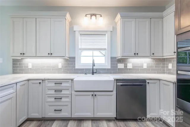 a kitchen with cabinets appliances and a sink