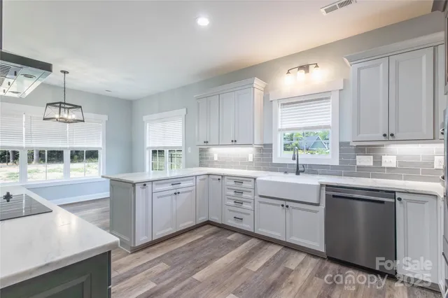 a kitchen with a sink stove and cabinets