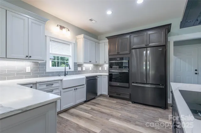 a kitchen with a refrigerator stove and sink