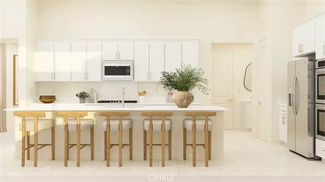 a white kitchen with a sink and white cabinets