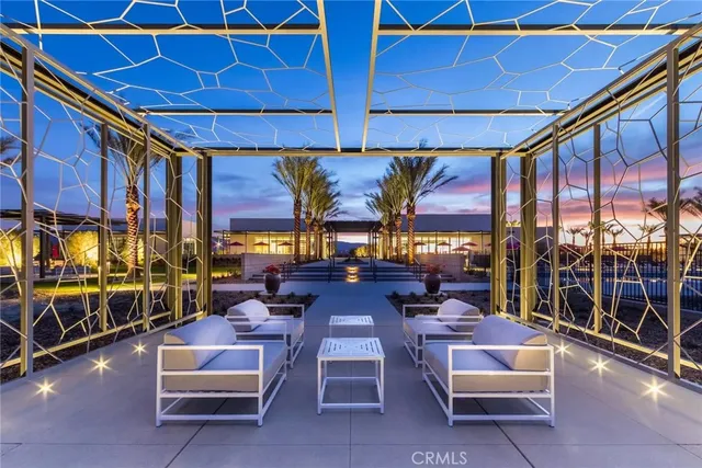 a view of a swimming pool and lounge chairs